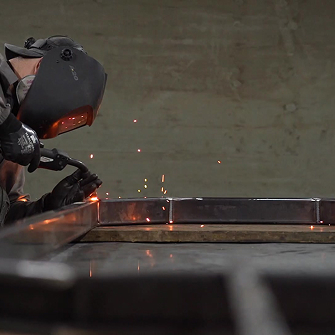 Man welding a piece Man welding a piece